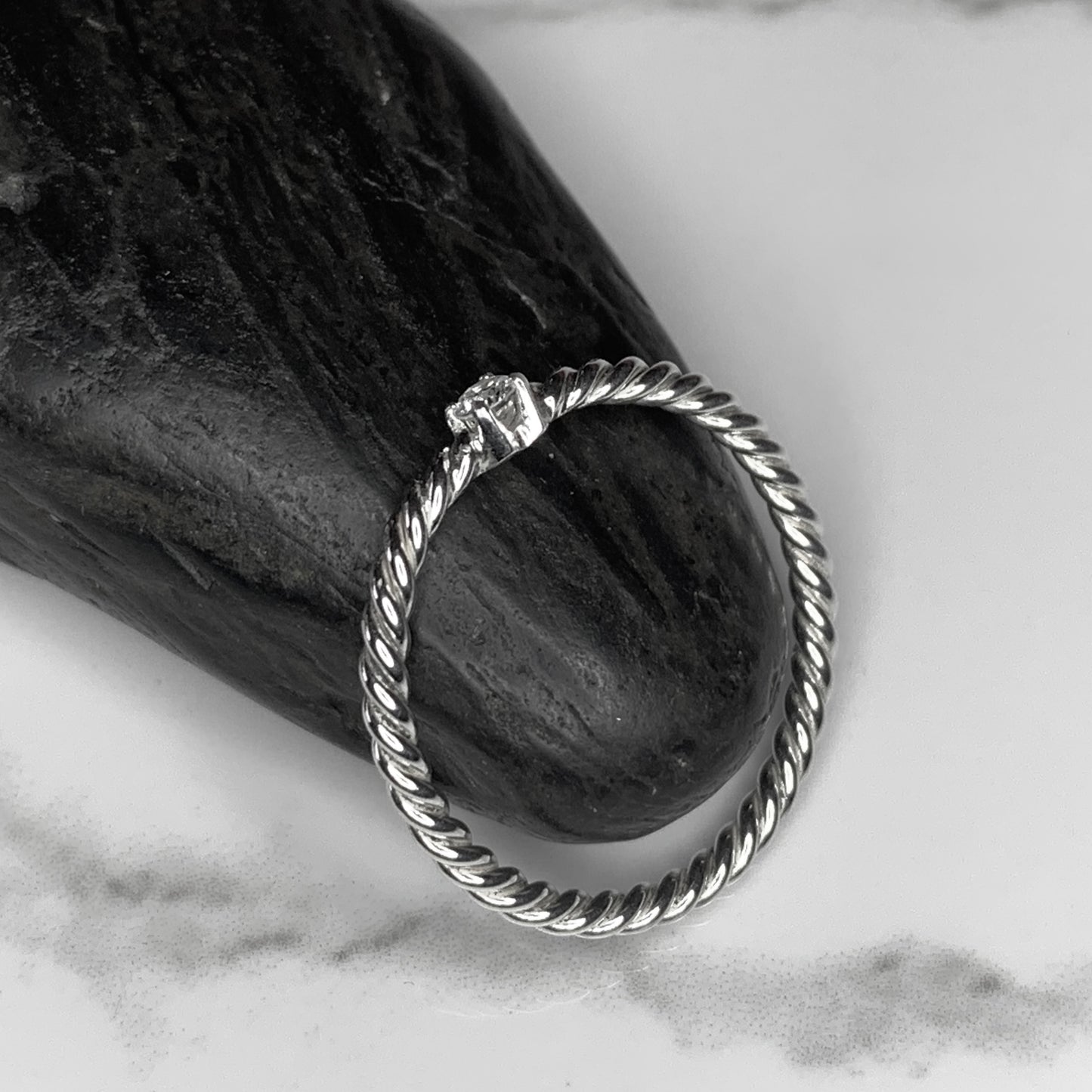 Solitaire Ring with 2.5mm, 0.06ct. Diamond on rope band.