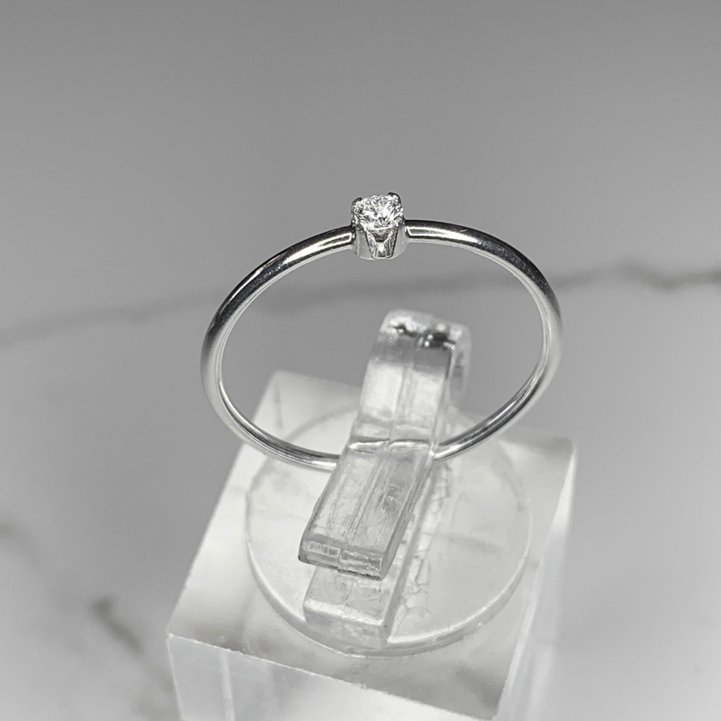 Solitaire Ring with 2.5mm, 0.06ct. Diamond with plain band.